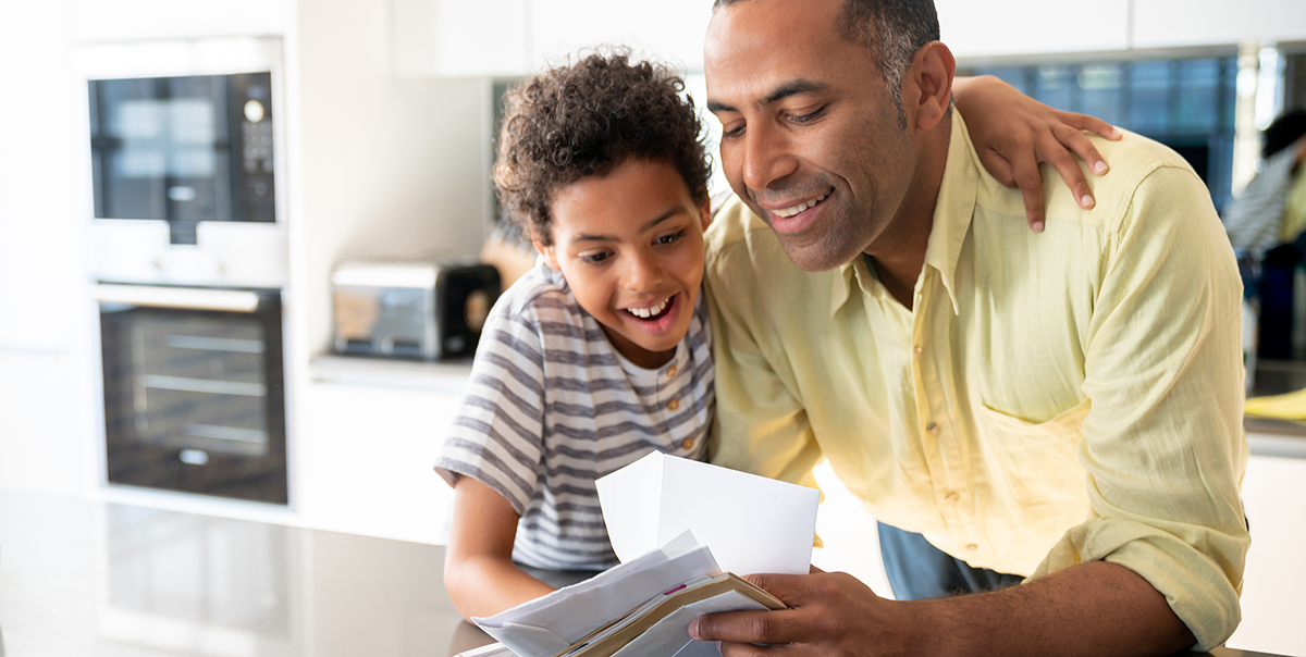 Father and son checking mail together