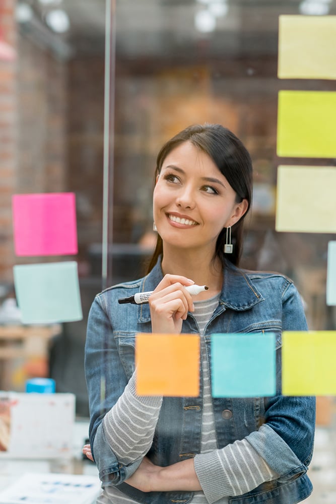 Portrait of a UX designer with post-it notes.