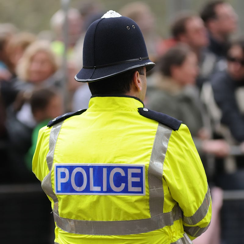 Police officer looking at a crowd of people