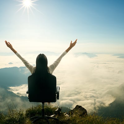 A woman on a chair above the clouds