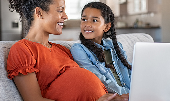 Woman and daughter looking at a laptop