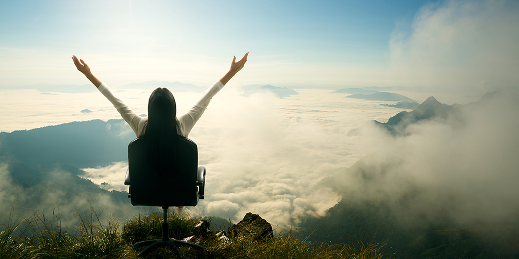 Person sitting on a wheeled chair among the clouds