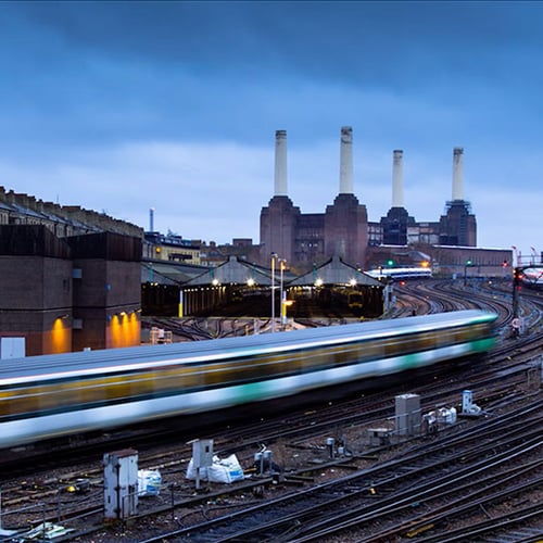 Train speeding past Battersea Power Station
