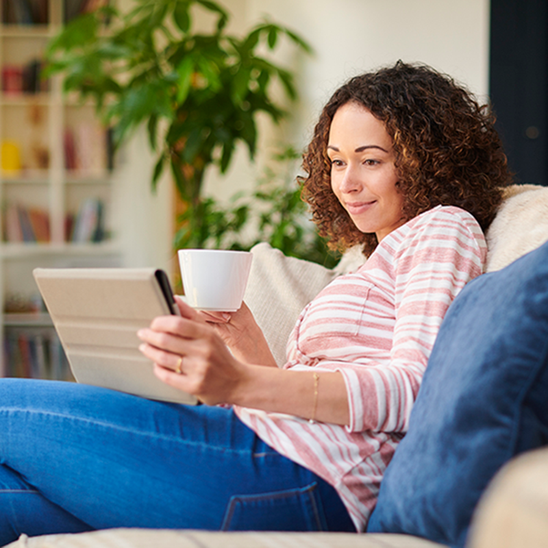 Woman on her digital tablet at home