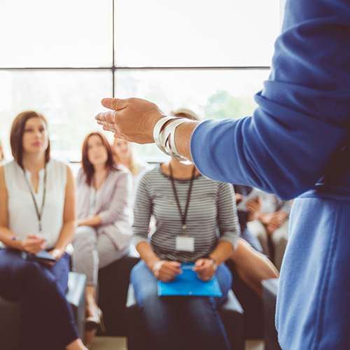 A person presenting at a talk A person presenting at a talk