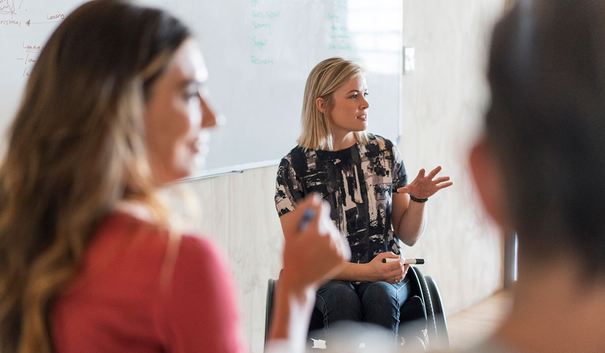 Person giving presentation in office