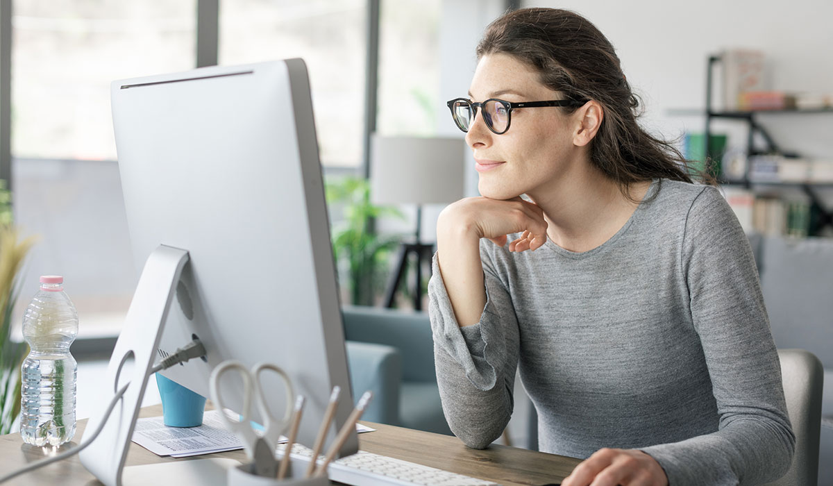 Person sat at desk looking at computer monitor