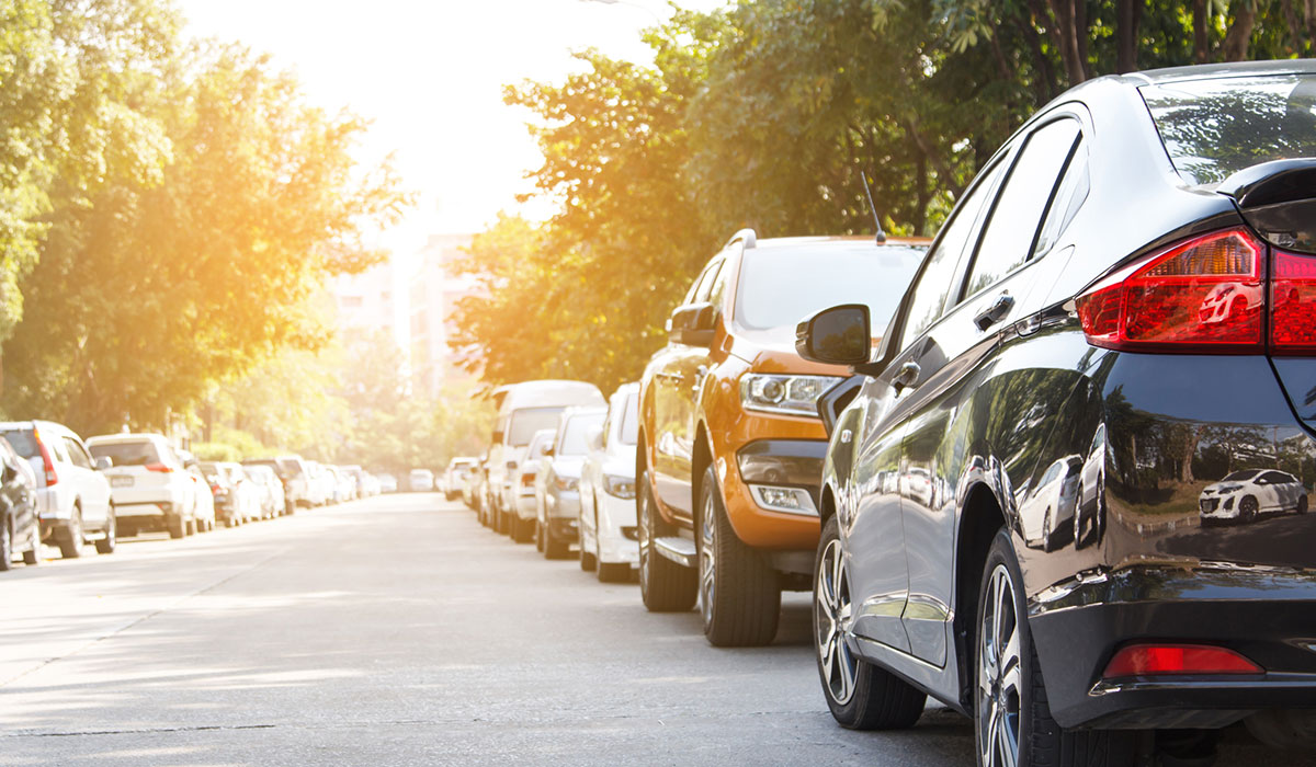 Cars parked on either side of the street outdoors