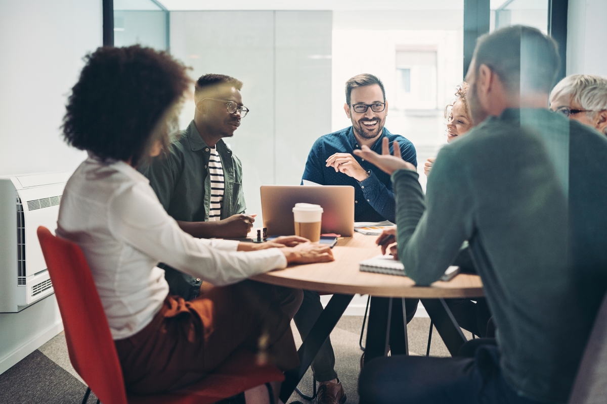 A group of colleagues having a discussion around a table