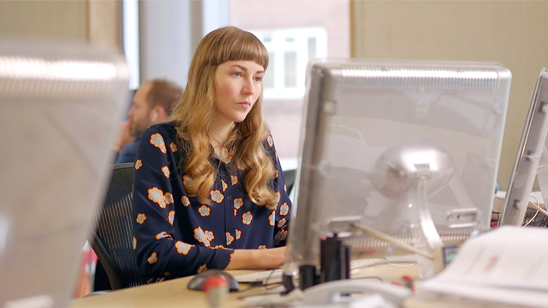 Social worker sat at a computer