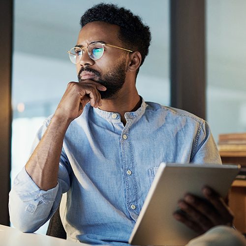 Man sat at desk in deep thought